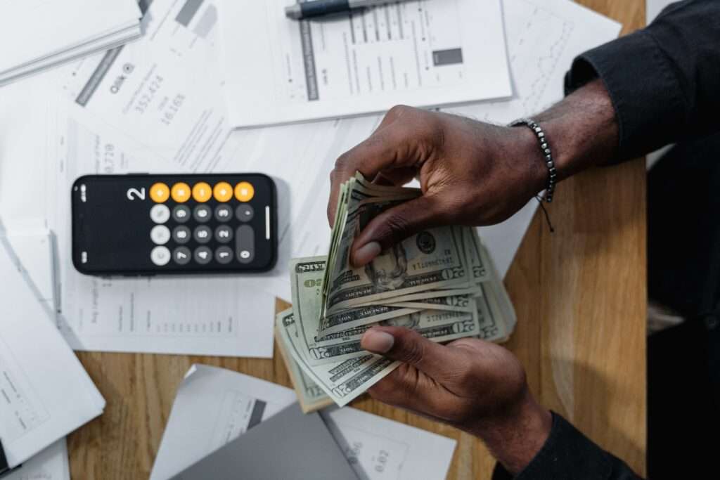 Man counting money and calculating his budget